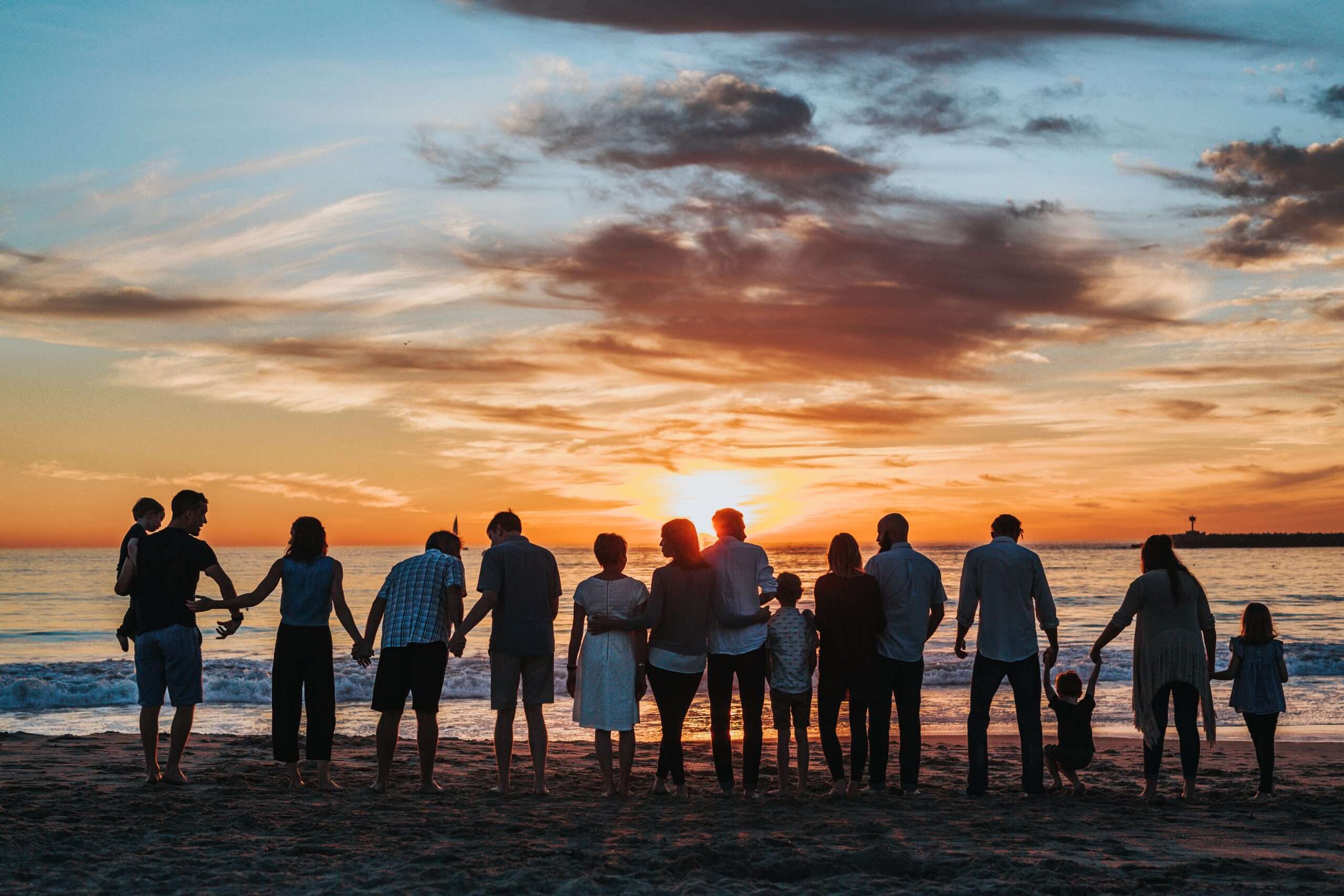 rbb menbers together on beach with faimly